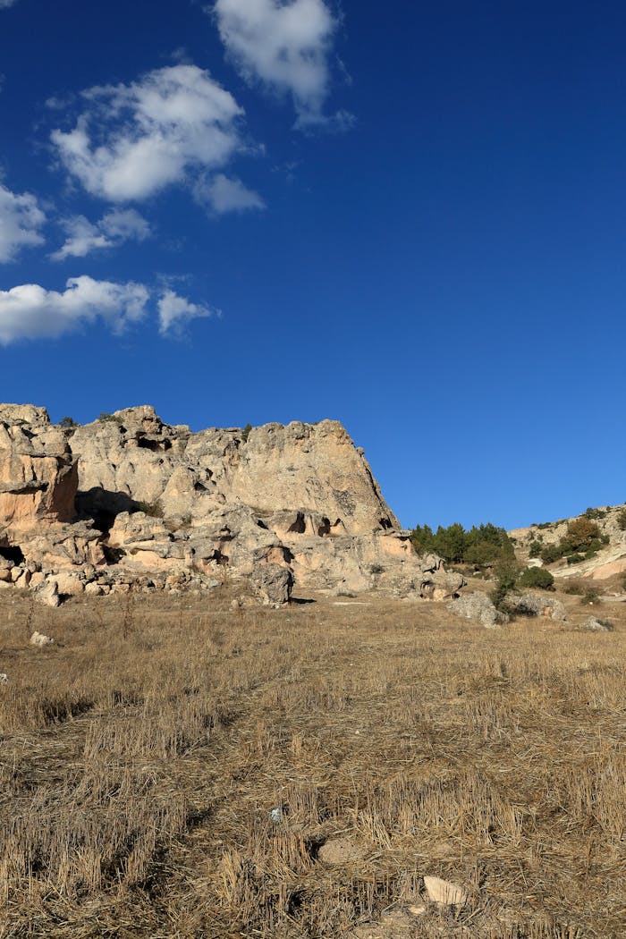 Explore this breathtaking rocky landscape under a bright blue sky, perfect for adventure enthusiasts.